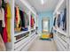 Custom walk-in closet with built-in shelving, ample storage, and a mirror for dressing convenience at 5724 Shell Ridge Dr, Lithia, FL 33547