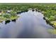 Wide aerial view captures the tranquil lake, lush trees, and lakefront properties, highlighting a serene neighborhood at 5817 Myrtle Ln, Tampa, FL 33625