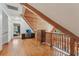 View of attic space with wooden floors, ceiling, rails, and a chest of drawers plus a desk at 5817 Myrtle Ln, Tampa, FL 33625