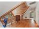 View of attic space with wooden floors, ceiling, rails, and a chest of drawers at 5817 Myrtle Ln, Tampa, FL 33625