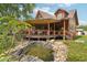 Cabin home boasts a gorgeous covered deck overlooking a tranquil koi pond feature at 5817 Myrtle Ln, Tampa, FL 33625