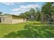 Lush backyard with a utility shed, trampoline, and a playset at 5817 Myrtle Ln, Tampa, FL 33625