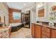 Bathroom featuring soaking tub, separate shower, wood walls, and tile floors at 5817 Myrtle Ln, Tampa, FL 33625
