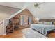 Bedroom featuring sloped ceilings, exposed wood walls and hardwood floors at 5817 Myrtle Ln, Tampa, FL 33625
