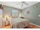 Inviting bedroom with hardwood floors, bedside tables with lamps, and a window at 5817 Myrtle Ln, Tampa, FL 33625