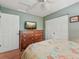 Comfortable bedroom with hardwood floors, closet, and a dresser with mounted TV at 5817 Myrtle Ln, Tampa, FL 33625