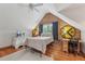 View of the bedroom with wood-paneled walls, a bed, a ceiling fan, and wood floors at 5817 Myrtle Ln, Tampa, FL 33625