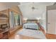 Bedroom featuring sloped ceilings, exposed wood walls and hardwood floors at 5817 Myrtle Ln, Tampa, FL 33625
