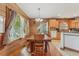 Rustic dining room features wood floors, matching walls, a long dining table, and an elegant chandelier fixture at 5817 Myrtle Ln, Tampa, FL 33625
