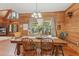 Charming dining room featuring hardwood floors, rustic wooden walls, and a large window at 5817 Myrtle Ln, Tampa, FL 33625