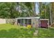 Exterior view of dog kennel in wooded backyard at 5817 Myrtle Ln, Tampa, FL 33625