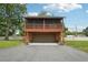 Two-story cabin home with a garage and screened balcony on the second floor at 5817 Myrtle Ln, Tampa, FL 33625