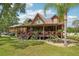 Inviting log-cabin-style home with a spacious covered porch and lush landscaping at 5817 Myrtle Ln, Tampa, FL 33625