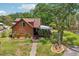 Rustic cabin-style home with beautiful landscaping and brick walkway leading to the inviting entrance at 5817 Myrtle Ln, Tampa, FL 33625