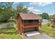 Cabin home with spacious two-story garage featuring a balcony and a large driveway at 5817 Myrtle Ln, Tampa, FL 33625