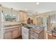 Charming kitchen with light wood cabinets, granite countertops, and modern appliances at 5817 Myrtle Ln, Tampa, FL 33625