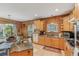 Well-lit kitchen with wood floors, wooden cabinets, stainless steel appliances, and ample counter space at 5817 Myrtle Ln, Tampa, FL 33625