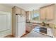 Functional kitchen with light wood cabinets, granite countertops, and essential appliances at 5817 Myrtle Ln, Tampa, FL 33625