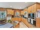 Charming kitchen with wooden cabinets, stainless steel appliances, and granite countertops at 5817 Myrtle Ln, Tampa, FL 33625