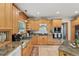 Bright kitchen with ample cabinets, stone countertops, stainless appliances, and a view from the window at 5817 Myrtle Ln, Tampa, FL 33625