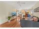Living room area next to the kitchen with gray sofa, wood floors, and ceiling fan at 5817 Myrtle Ln, Tampa, FL 33625