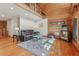 Cozy living room featuring wooden walls and floors and a comfortable leather sofa at 5817 Myrtle Ln, Tampa, FL 33625