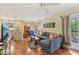 Living room area next to the kitchen with gray sofa, wood floors, and ceiling fan at 5817 Myrtle Ln, Tampa, FL 33625