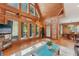 Living room featuring hardwood floors, wooden walls, and large windows at 5817 Myrtle Ln, Tampa, FL 33625