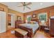 Cozy bedroom featuring natural wood walls, hardwood floors, and a comfortable king size bed at 5817 Myrtle Ln, Tampa, FL 33625
