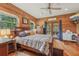 This primary bedroom features wood walls, and natural light from the doors to the deck at 5817 Myrtle Ln, Tampa, FL 33625
