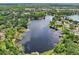 Stunning aerial view of a lake with waterfront properties, docks, and lush green surroundings at 5817 Myrtle Ln, Tampa, FL 33625