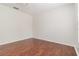 Clean, modern bedroom features hardwood floors and neutral paint at 5839 Meadowpark Pl, Lithia, FL 33547