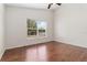 Well-lit bedroom with hardwood floors and a window for natural light at 5839 Meadowpark Pl, Lithia, FL 33547