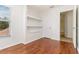 Cozy bedroom featuring hardwood floors, built-in shelving and an ensuite bath at 5839 Meadowpark Pl, Lithia, FL 33547
