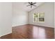 Bright bedroom featuring hardwood floors, a ceiling fan, and a large window at 5839 Meadowpark Pl, Lithia, FL 33547