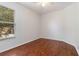 Bright bedroom with hardwood floors, ceiling fan and natural light from large window at 5839 Meadowpark Pl, Lithia, FL 33547