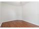 A simply styled room has clean white walls, beautiful wood floors and a ceiling fan at 5839 Meadowpark Pl, Lithia, FL 33547