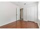 Cozy bedroom with hardwood floors and a closet, next to an open doorway at 5839 Meadowpark Pl, Lithia, FL 33547