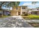 Inviting two-story home featuring a well-maintained lawn and a convenient one-car garage at 5839 Meadowpark Pl, Lithia, FL 33547