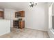 Kitchen and dining area featuring tiled floors, wood cabinets, and stainless steel appliances at 5839 Meadowpark Pl, Lithia, FL 33547