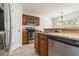 Kitchen area showcasing stainless steel appliances, wood cabinets, and granite countertops at 5839 Meadowpark Pl, Lithia, FL 33547