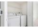 Convenient laundry room with modern washer and dryer units and wire shelving at 5839 Meadowpark Pl, Lithia, FL 33547