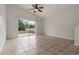 Bright living room with tiled floors and a sliding glass door to the backyard at 5839 Meadowpark Pl, Lithia, FL 33547