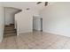 Spacious living area with tiled floors and stairs leading to the upper level at 5839 Meadowpark Pl, Lithia, FL 33547