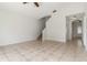 Open living room featuring tiled floors and a staircase leading to the upper level at 5839 Meadowpark Pl, Lithia, FL 33547