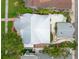 An aerial view shows the white exterior, crisp roof, and beautiful landscaping of this single-Gathering home at 626 16Th Ne Ave, St Petersburg, FL 33704