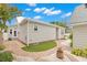Well-manicured backyard with brick path, white gravel, and lush landscaping creating a private outdoor space at 626 16Th Ne Ave, St Petersburg, FL 33704
