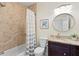 Cozy bathroom with a tub/shower combo and a charming vanity with framed mirror at 626 16Th Ne Ave, St Petersburg, FL 33704