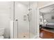 Modern bathroom with a glass-enclosed shower, white tile, and access to the main bedroom at 626 16Th Ne Ave, St Petersburg, FL 33704