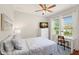 Cozy bedroom features a ceiling fan, two windows, and a dedicated workspace with a desk at 626 16Th Ne Ave, St Petersburg, FL 33704